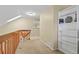 Upstairs hallway with bookshelves, artwork, and natural light from a skylight at 5317 W Iliff Dr # 101, Lakewood, CO 80227