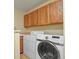 Laundry room with Samsung washer and dryer, wooden cabinets, and a utility sink at 5317 W Iliff Dr # 101, Lakewood, CO 80227
