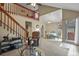 Open-concept living room with a staircase, dining area, and access to the patio at 5317 W Iliff Dr # 101, Lakewood, CO 80227