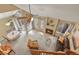 Aerial view of living room with fireplace, dining table, leather sofa, and large windows at 5317 W Iliff Dr # 101, Lakewood, CO 80227