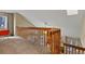 Loft area overlooking the living room, featuring wooden railings at 5317 W Iliff Dr # 101, Lakewood, CO 80227