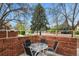 Cozy outdoor patio with brick surround and seating, perfect for entertaining at 5317 W Iliff Dr # 101, Lakewood, CO 80227