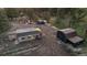 Aerial view of a property with multiple buildings and surrounding trees at 34480 County Road 17, Elizabeth, CO 80107