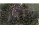 Aerial view of a property with multiple buildings surrounded by lush green trees and open space at 34480 County Road 17, Elizabeth, CO 80107