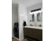 Updated bathroom with a double vanity, modern fixtures, and convenient washer/dryer hookups at 34480 County Road 17, Elizabeth, CO 80107
