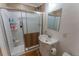 Bathroom featuring a shower with glass doors and a modern vanity sink at 34480 County Road 17, Elizabeth, CO 80107