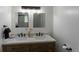 Bathroom vanity featuring double sinks, quartz countertop, wood cabinets, and modern light fixture at 34480 County Road 17, Elizabeth, CO 80107
