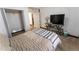 Bright bedroom with a bed and TV, offering ample space and a view of the closet at 34480 County Road 17, Elizabeth, CO 80107