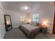 Bedroom with neutral carpet, comfortable bed, two windows, and an accent mirror at 34480 County Road 17, Elizabeth, CO 80107