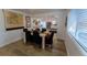 Bright dining room features wood floors, a modern table, and a view into the updated kitchen at 34480 County Road 17, Elizabeth, CO 80107