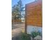 Driveway featuring a new wooden fence, white flowers, and trees in the background at 34480 County Road 17, Elizabeth, CO 80107