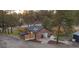 Charming brick home with a well-maintained yard, updated fence and stone patio surrounded by mature trees at 34480 County Road 17, Elizabeth, CO 80107