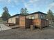 Home exterior showcasing a private patio surrounded by a rustic wooden privacy fence at 34480 County Road 17, Elizabeth, CO 80107