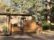 Charming front entrance with wooden privacy screen, brick exterior, and flower boxes at 34480 County Road 17, Elizabeth, CO 80107