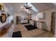 Open concept kitchen with stainless steel appliances, white cabinets, butcher block counters, skylights, and wood floors at 34480 County Road 17, Elizabeth, CO 80107