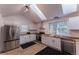 Bright kitchen with stainless steel appliances, light wood floors, butcher block counters, and skylights at 34480 County Road 17, Elizabeth, CO 80107