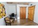 Bright office space with wood floors, featuring a desk and chair with natural wood trim at 34480 County Road 17, Elizabeth, CO 80107