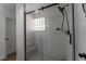 Modern glass shower with stylish black hardware, marble bench, glass block window and tiled floor at 34480 County Road 17, Elizabeth, CO 80107