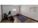 Bright workout room featuring wood floors, a stationary bike, exercise ball, and a patterned rug at 34480 County Road 17, Elizabeth, CO 80107