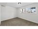 Simple and bright basement bedroom with neutral walls and carpet at 3530 W Edgemore Pl, Englewood, CO 80110