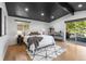 Bright bedroom with a king-size bed, and access to a private deck at 6949 S Sheridan Blvd, Littleton, CO 80128