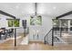 Open entryway with light hardwood floors and modern staircase at 6949 S Sheridan Blvd, Littleton, CO 80128