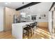 Modern kitchen featuring light wood cabinets, a large island, and stainless steel appliances at 6949 S Sheridan Blvd, Littleton, CO 80128