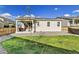 Backyard featuring a covered patio and lush green grass, perfect for outdoor living at 27862 E 9Th Dr, Aurora, CO 80018
