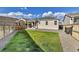 A well-maintained backyard features a cozy covered patio and lush green grass, perfect for outdoor living at 27862 E 9Th Dr, Aurora, CO 80018