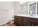 Bathroom featuring a modern vanity with a white countertop, dark wood cabinets and a shower at 27862 E 9Th Dr, Aurora, CO 80018