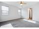 Bedroom featuring carpet, white walls, a ceiling fan and three windows at 27862 E 9Th Dr, Aurora, CO 80018