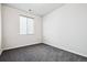 Empty bedroom featuring carpet, white walls, and a window at 27862 E 9Th Dr, Aurora, CO 80018