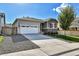 Charming single-Gathering home showcasing manicured landscaping, stone accents, and an attached two-car garage at 27862 E 9Th Dr, Aurora, CO 80018