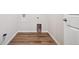 Compact laundry room with laminate floors, ready for washer and dryer hookups at 27862 E 9Th Dr, Aurora, CO 80018