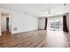 Open living room with hardwood floors and sliding glass doors, providing plenty of natural light at 27862 E 9Th Dr, Aurora, CO 80018