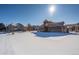 Community pool area and clubhouse in snowy setting at 12886 Jasmine St # B, Thornton, CO 80602