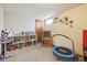 Playful basement room with a trampoline and toys at 1660 S Cook St, Denver, CO 80210