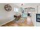 Bright dining area with hardwood floors and a view into the updated kitchen at 1660 S Cook St, Denver, CO 80210