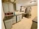 A laundry room with storage cabinets, counters, a utility sink and a stackable washer and dryer at 1660 S Cook St, Denver, CO 80210