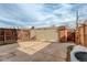 Backyard view with a storage shed, wooden fence, and concrete patio at 13015 W Ohio Ave, Lakewood, CO 80228