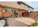 Backyard with brick facade, patio and small staircase leading to a sliding glass door at 13015 W Ohio Ave, Lakewood, CO 80228