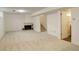 Unstaged basement featuring a fireplace, carpeting, and access to the stairs and a door at 13015 W Ohio Ave, Lakewood, CO 80228