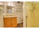 Bathroom featuring a shower, wood-look flooring, and a sink with storage at 13015 W Ohio Ave, Lakewood, CO 80228