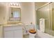 Bathroom featuring a shower/tub with a glass door, a sink, and a toilet at 13015 W Ohio Ave, Lakewood, CO 80228