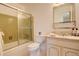 Bathroom featuring a shower/tub with a glass door, a sink, and a toilet at 13015 W Ohio Ave, Lakewood, CO 80228