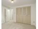 Bedroom featuring neutral carpeting, a closet, and access to another room at 13015 W Ohio Ave, Lakewood, CO 80228