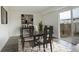 Elegant dining room with modern table, chairs, and sliding glass doors to the backyard at 13015 W Ohio Ave, Lakewood, CO 80228