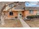 Charming brick townhome with a well-maintained front yard and inviting entrance at 13015 W Ohio Ave, Lakewood, CO 80228