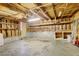 Spacious unfinished garage with shelving, concrete floor and overhead lighting at 13015 W Ohio Ave, Lakewood, CO 80228