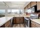 Well-lit kitchen with stainless steel appliances, and modern floors at 13015 W Ohio Ave, Lakewood, CO 80228